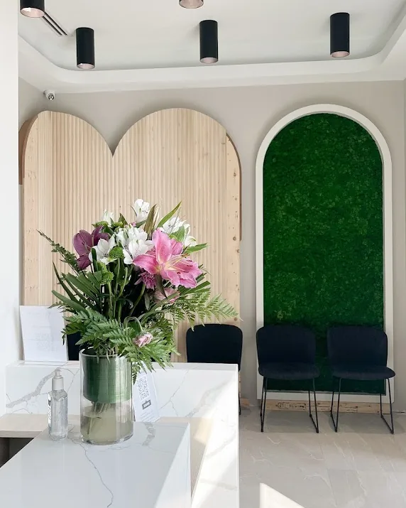Front desk with hand sanitizer and the waiting area at Yonge Forest Dental