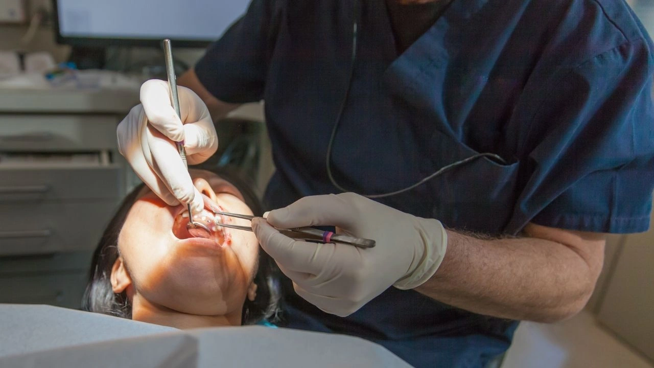 Dentist performing tooth extraction procedure on a patient at Yonge Forest Dental in Barrie