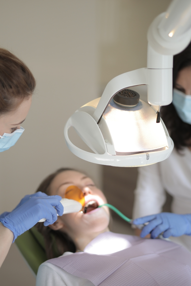 Emergency dental treatment with curing light performed on a patient – Yonge Forest Dental Barrie.
