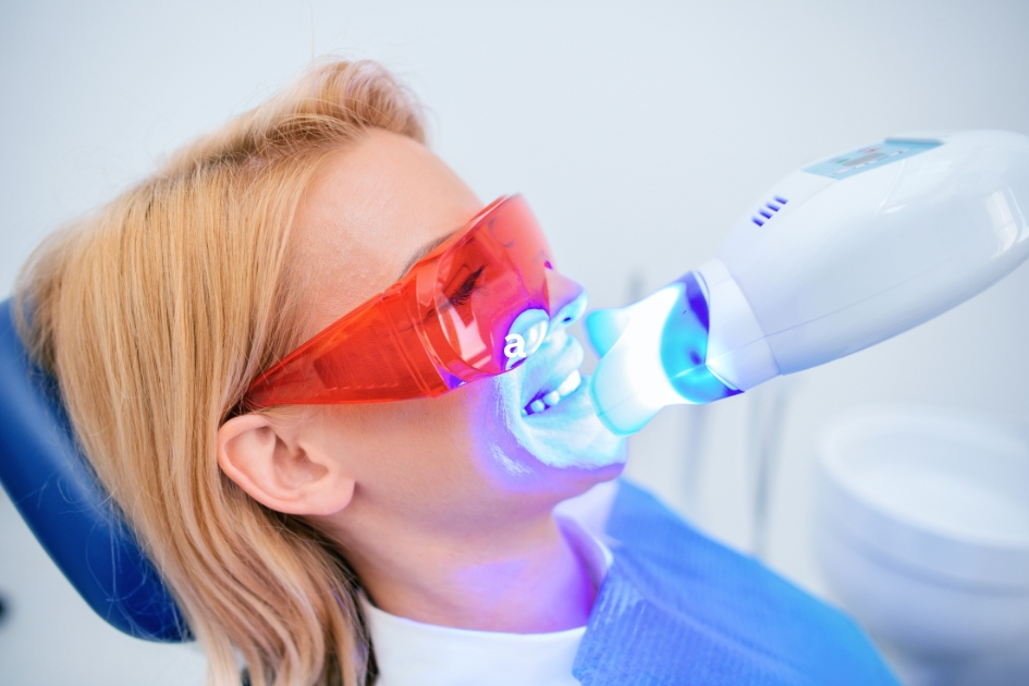 Dental patient receiving in-office teeth whitening with advanced blue light technology at Yonge Forest Dental in Barrie.