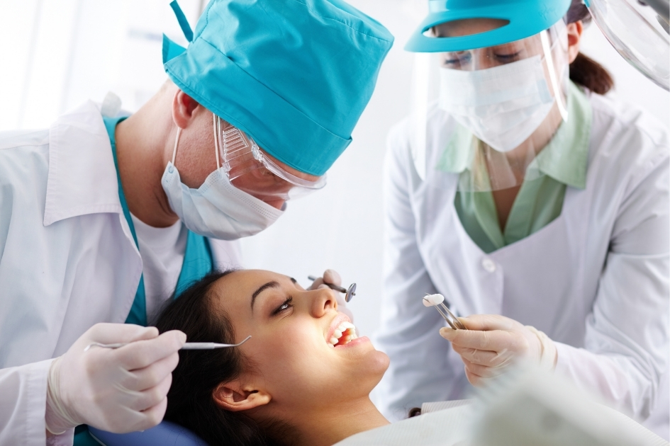 Dental surgeon performing oral surgery procedure on a patient at Yonge Forest Dental in Barrie